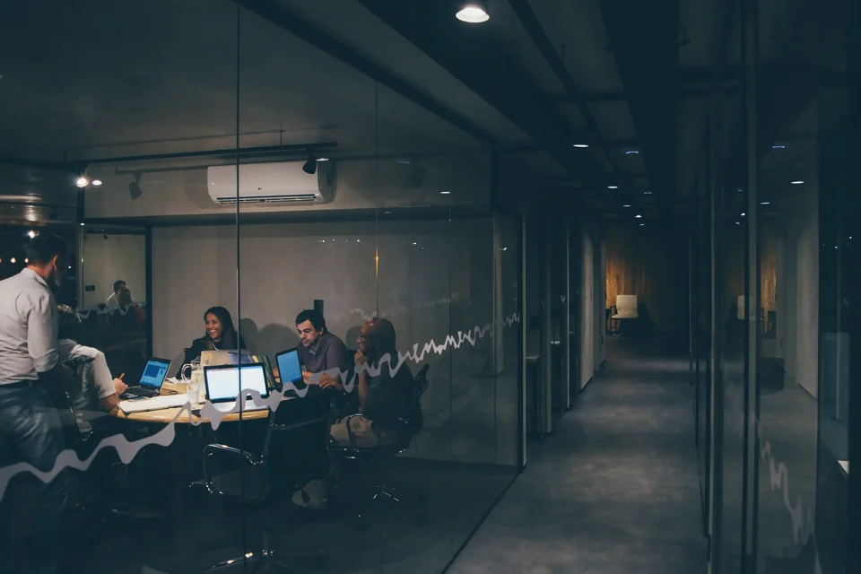 A team working late in a glass-walled office