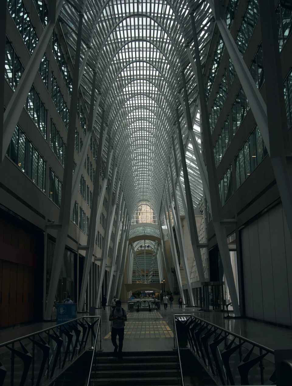 A glass-roofed galleria between office towers