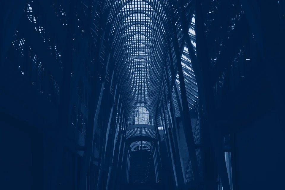 A glass-roofed galleria between office towers