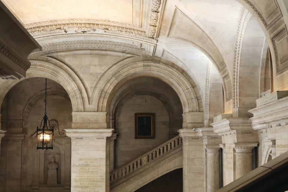 Stone arches and a staircase in a library