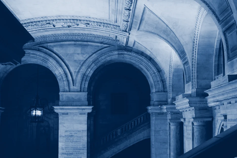 Stone arches and a staircase in a library
