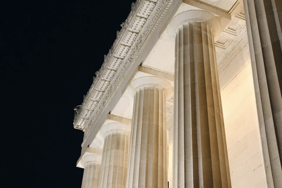Floodlit stone columns at night