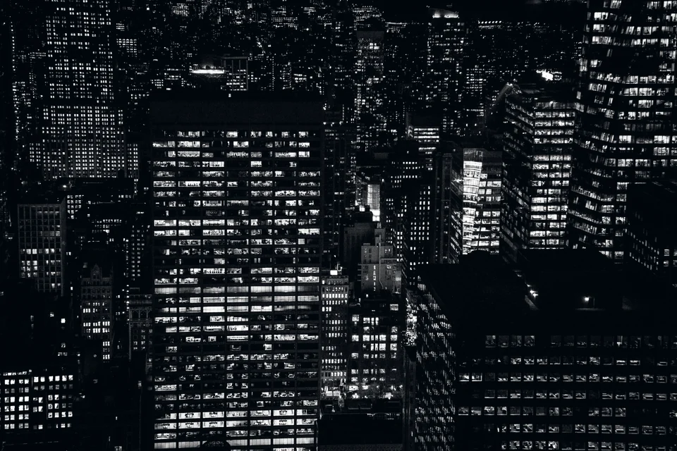 Lit office windows across a city at night