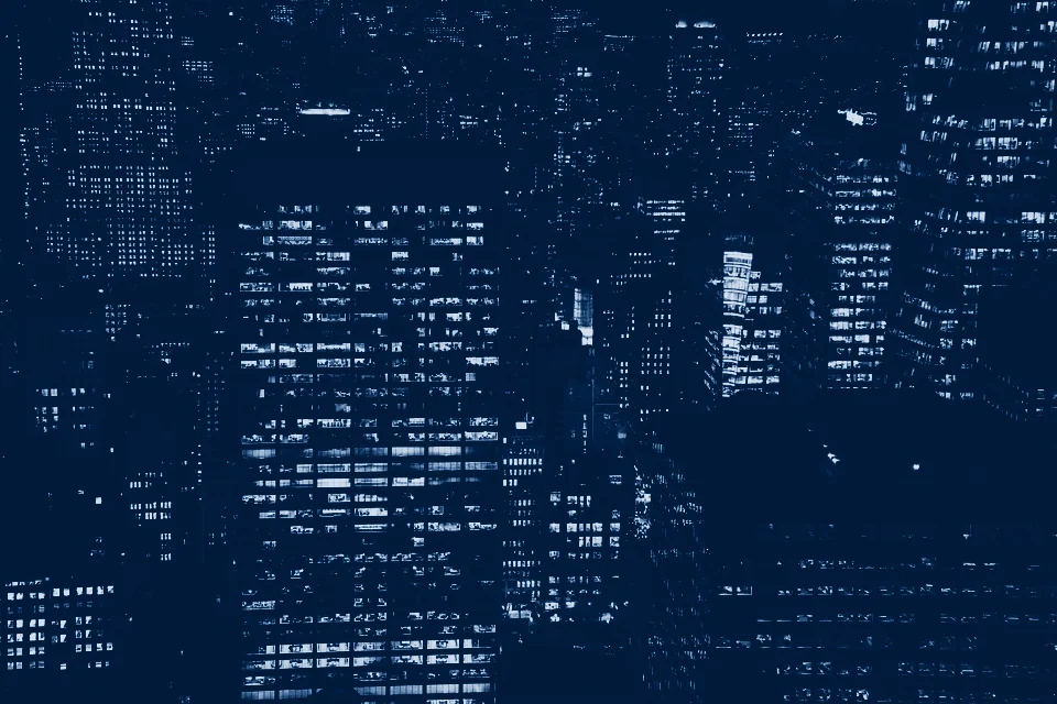 Lit office windows across a city at night