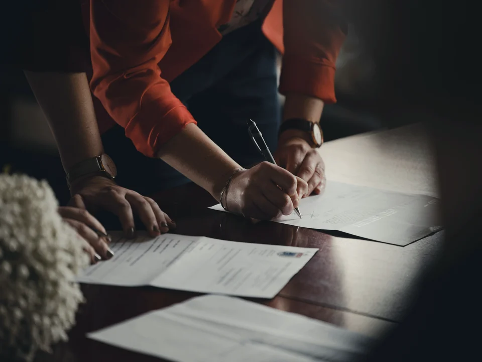 Documents being signed at a desk